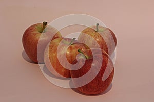 Group of red apples on a pink background