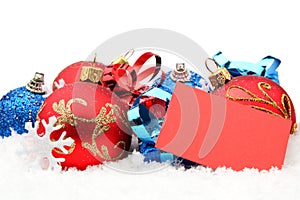 Group of red,blue christmas decoration with wishes card on snow