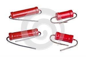 Group of red carbon power resistors with bent lead wires isolated on white background