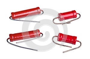 Group of red carbon power resistors with bent lead wires isolated on white background photo