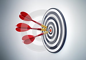 Group of red darts hitting a dartbord