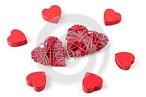 Group or red hearts isolated on white, six wooden and two strawy photo