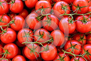 Group of red ripe and delicious tomatoes for sale in an urban market in france