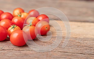 Group red tomatoes on the wooden table