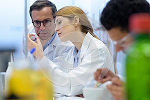 group researchers during work on devices in laboratory