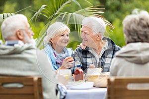 Group of retired friends having fun during birthday party at the garden