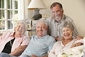 Group Of Retired Friends Sitting On Sofa At Home Together