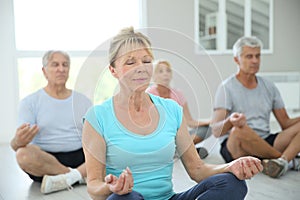 Group of retired people relaxing doing yoga excercises