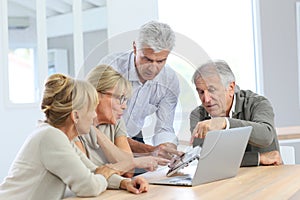 Group of retired people using electronical devices