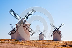 Group of retro windmills in field