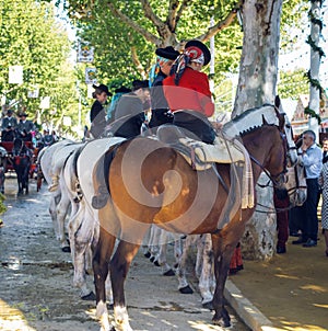 Group of riders on horseback enjoy April Fair, Seville Fair Feria de Sevilla.