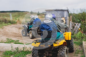 Group of riders riding atv vehicle on off road track, process of driving ATV vehicle, all terrain quad bike vehicle, during