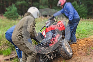 Group of riders riding atv vehicle on off road track, process of driving ATV vehicle, all terrain quad bike vehicle, during
