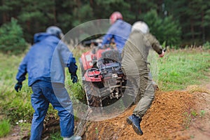 Group of riders riding atv vehicle on off road track, process of driving ATV vehicle, all terrain quad bike vehicle, during