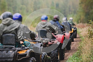 Group of riders riding atv vehicle on off road track, process of driving ATV vehicle, all terrain quad bike vehicle, during