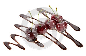 Group of ripe cherries dipped in melted chocolate on white background