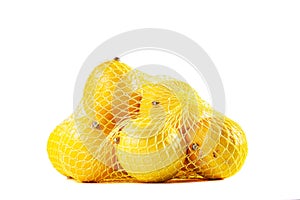 group of ripe lemons in a mesh bag against white background