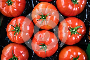 group of ripe red tomatoes in grocery produce