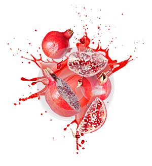 Group of ripe whole and sliced pomegranates with splashes of juice in the air on a white background