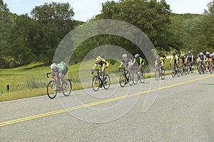 A group of road bicyclists traveling across highway 58 in CA