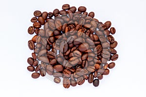 A group of roasted coffee beans, fresh brown in colour, ready to be grinded and made drinks