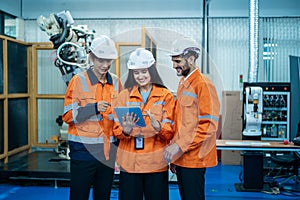 Group of Robotics engineers working with Programming and Manipulating Robot Hand, Industrial Robotics Design, High Tech Facility