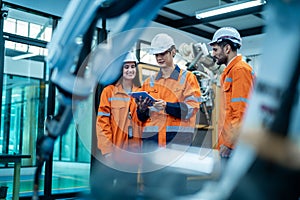 Group of Robotics engineers working with Programming and Manipulating Robot Hand, Industrial Robotics Design, High Tech Facility