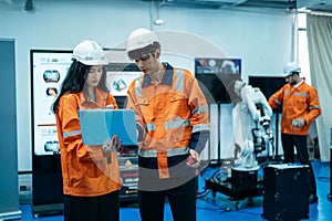 Group of Robotics engineers working with Programming and Manipulating Robot Hand, Industrial Robotics Design, High Tech Facility