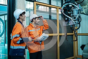 Group of Robotics engineers working with Programming and Manipulating Robot Hand, Industrial Robotics Design, High Tech Facility