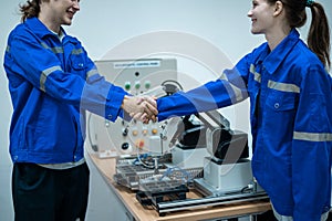 Group of Robotics engineers working with Programming and Manipulating Robot Hand, Industrial Robotics Design, High Tech Facility
