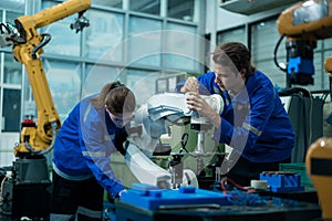 Group of Robotics engineers working with Programming and Manipulating Robot Hand, Industrial Robotics Design, High Tech Facility