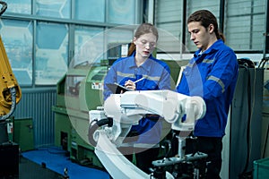 Group of Robotics engineers working with Programming and Manipulating Robot Hand, Industrial Robotics Design, High Tech Facility