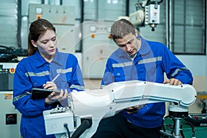 Group of Robotics engineers working with Programming and Manipulating Robot Hand, Industrial Robotics Design, High Tech Facility