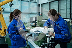 Group of Robotics engineers working with Programming and Manipulating Robot Hand, Industrial Robotics Design, High Tech Facility