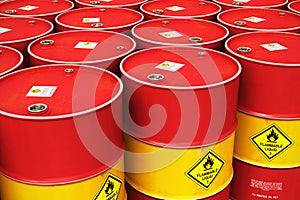 Group of rows of red stacked oil drums in storage warehouse