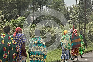 Group of rural Rwandan women in colorful traditionals clothes walking along the road, Kigali, Rwanda