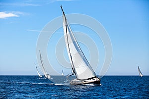 Group of sail yachts in regatta in open the Sea. Boat in sailing regatta.