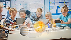 Group of School Children in Science Class Use Digital Tablet Computers with Augmented Reality