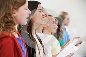 Group Of School Children Singing In Choir Together