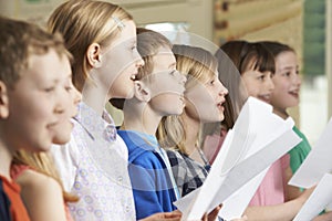 Group Of School Children Singing In School Choir