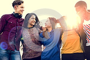 Group of school friends outdoors arms around one another togetherness and community concept