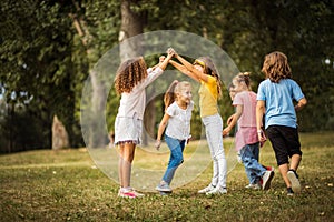 Group of school kids having fun in nature