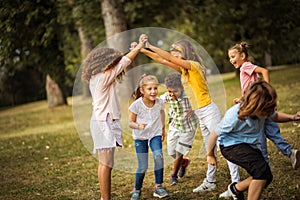 Group of school kids having fun in nature