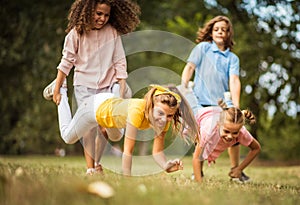 Group of school kids having fun in nature. Focus is on foreground Funny time