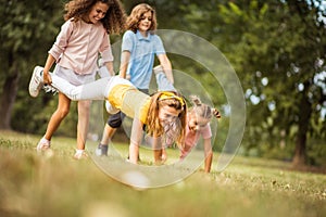 Group of school kids having fun in nature Funny time