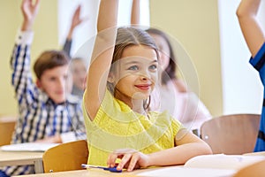 Group of school kids with notebooks in classroom