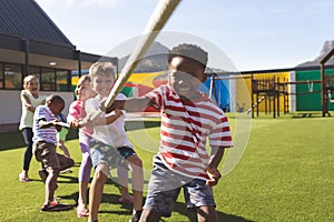 Group of school kids playing tug of war