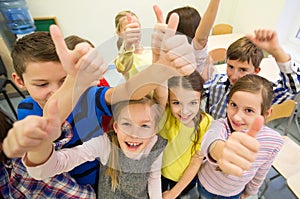 Group of school kids showing thumbs up