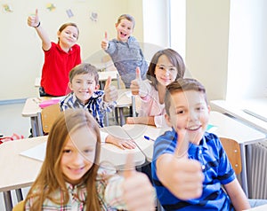 Group of school kids showing thumbs up