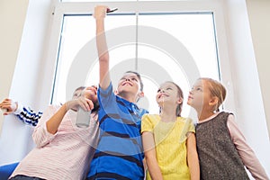 Group of school kids with smartphone and soda can